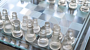 Chess game. Chess pieces made of glass. Rivalry concept. Selective focus included