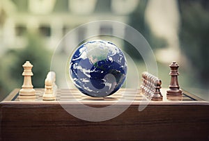 Chess game figures earth globe on home background