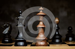 Chess game king checkmate defeat on vintage chessboard
