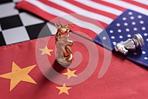 Chess game. Knight with crown stand as winner over the enemies on China and USA national flags. Trade war concept