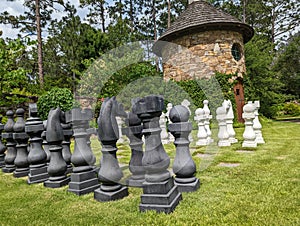 Chess game on lawn with stone building in the background