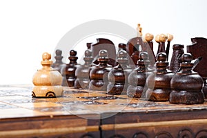 Chess game with lonely white pawn in front of enemies