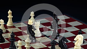 Chess game. Man making move with white bishop on chessboard during chess game isolated on black background. Chessman