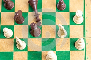 Chess game pieces on the green board