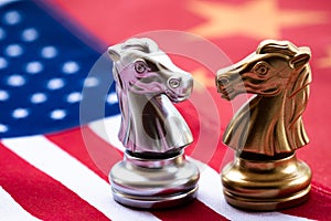 Chess game, two knights face to face on China and US national flags. Trade war concept. Conflict between two big countries, USA