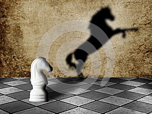 Chess horse with shadow as a wild horse on chessboard. Potentiality concept photo