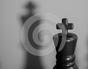 Chess King Casting Large Shadow on Board: Concept of Potential and Perception