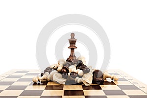 Chess king on a pile of defeated pieces