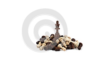 Chess king on a pile of defeated pieces