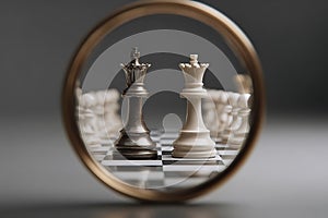 Chess kings and queens reflected in a mirror