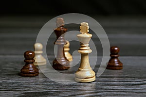 Chess kings on wooden background with pawns