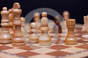 Chess, a lot of chess pieces on the Board. The white pieces surrounded the black pawn.
