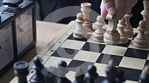 Chess. Man`s hand making a move with white knight