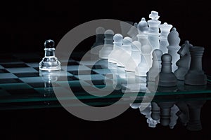 Chess pawn against all spotlight
