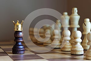 Chess pawn with golden crown confront the enemy team. Business leadership concept