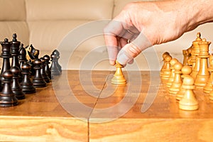 A chess pawn in a human hand. The beginning of the chess game. T