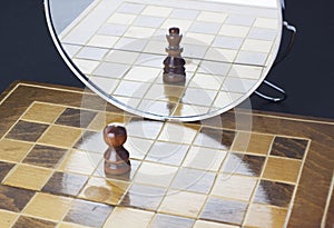 Chess pawn seeing himself in the mirror as a king