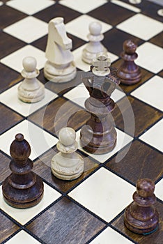 Chess piece figure standing on chess board photo