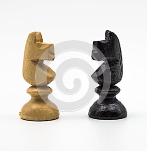 Chess pieces - black and white horse, on a white background.