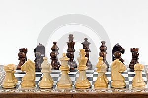 Chess pieces and board on white