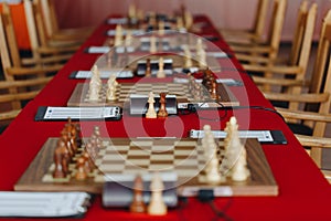 Chess pieces on a boart ready to play a game. Wood pieces of a game of chess on a board photo