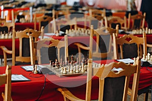 Chess pieces on a boart ready to play a game. Wood pieces of a game of chess on a board photo