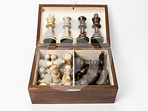Chess pieces in box with kings and queens displayed.
