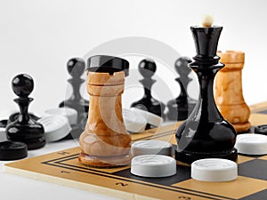 The chess pieces and checkers placed on the chessboard.