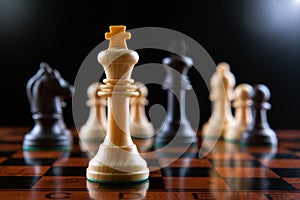 Chess pieces on a chessboard table and a chess piece of the king