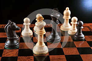Chess pieces on a chessboard table and a chess piece of the king
