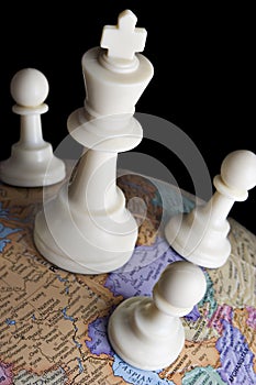 Chess pieces on an earth globe