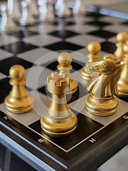 Chess pieces, focus on golden Rook