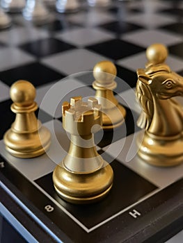 Chess pieces, focus on golden Rook