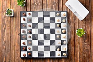 Chess pieces and game board on wooden table