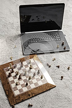 chess pieces  glasses and laptop or notebook computer