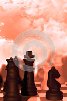 Chess pieces isolated against red sky