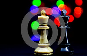 chess pieces king and queen on bokeh background