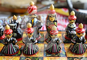 Chess pieces made in traditional Tajik style dressed in folk costumes