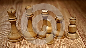 Chess pieces made of wood on a wooden table