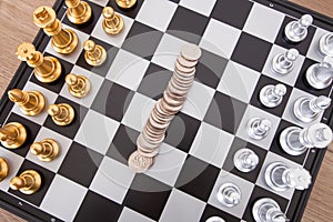 Chess pieces placed on the chessboard and the dollar coin in the middle