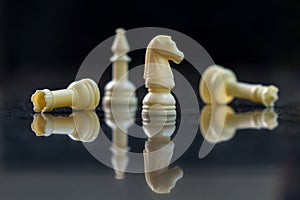 chess pieces on a reflective surface