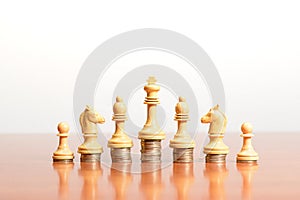 Chess pieces on stacked coins