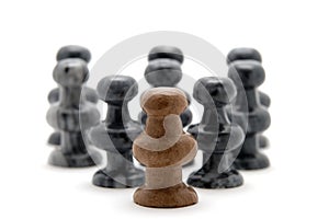 Chess pieces, white pawn leading black pieces