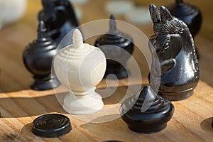 Chess pieces on wooden table, Planing game. chess uniqueness concept on the wooden background