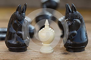 Chess pieces on wooden table, Planing game. chess uniqueness concept on the wooden background