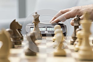 Chess player hitting the chess clock