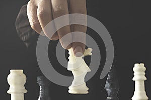 The chess player makes the winning move of the game, the concept of strategy to achieve success