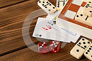 Chess, playing cards, dominoes on a wooden table. The concept of Board games