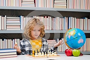 Chess school for children. Clever concentrated and thinking kid playing chess. Kids brain development and logic game.