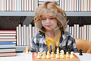Chess school for children. Little kid play chess. Thinking child. Chess game for kids. Intelligent, smart and clever